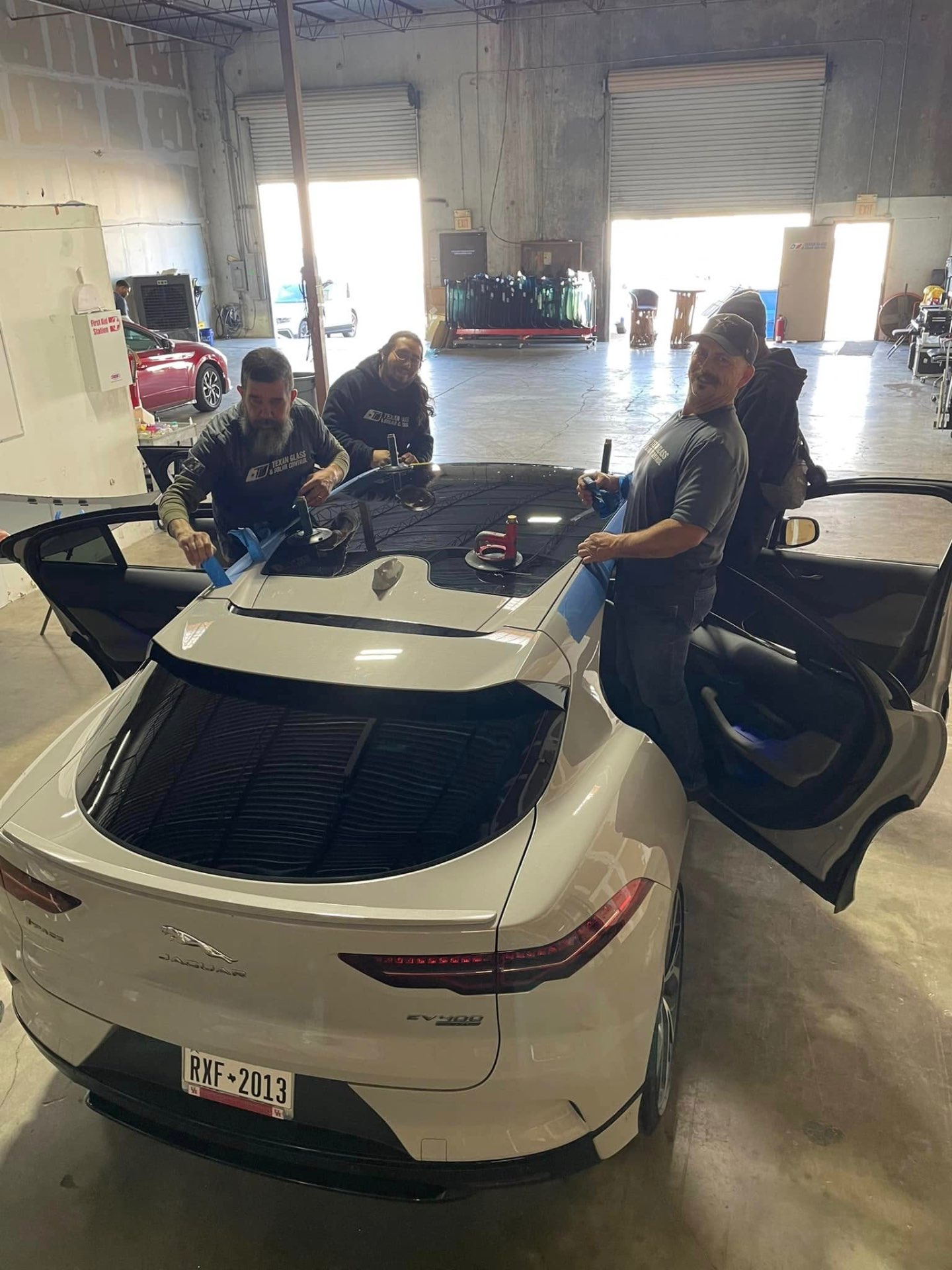 Our certified team replacing a luxury SUV windshield